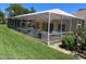 Screened patio area with seating at 7278 Scotland Cir, Weeki Wachee, FL 34613