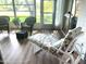 Sunroom with wicker chairs and chaise lounge at 7278 Scotland Cir, Weeki Wachee, FL 34613