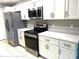 Modern kitchen with stainless steel appliances and white cabinets at 7278 Scotland Cir, Weeki Wachee, FL 34613