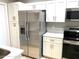 Modern kitchen with stainless steel appliances and white cabinets at 7278 Scotland Cir, Weeki Wachee, FL 34613