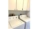 Clean laundry room, complete with washer and dryer at 7278 Scotland Cir, Weeki Wachee, FL 34613