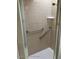Shower stall with grab bars and tiled walls at 7278 Scotland Cir, Weeki Wachee, FL 34613
