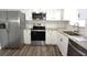 Updated kitchen with stainless steel appliances and wood-look flooring at 2252 Society Dr, Holiday, FL 34691