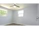 Simple bedroom with wood-look floors and two windows at 2252 Society Dr, Holiday, FL 34691