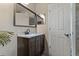 Bathroom features a vanity with dark brown cabinets and a large mirror at 9 Grace St, Crystal Beach, FL 34681