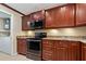 Modern kitchen features dark wood cabinets, granite countertops, and stainless steel appliances at 9 Grace St, Crystal Beach, FL 34681