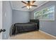 Cozy bedroom with double bed, ceiling fan, and tile flooring at 9 Grace St, Crystal Beach, FL 34681