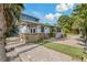 Stone and stucco exterior with covered patio at 9 Grace St, Crystal Beach, FL 34681