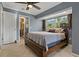 Main bedroom with queen bed, en-suite bathroom access, and ceiling fan at 9 Grace St, Crystal Beach, FL 34681