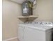 Bright laundry room with washer, dryer, and ample storage at 9 Grace St, Crystal Beach, FL 34681