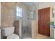 Bathroom with a walk-in shower, toilet, and wooden cabinets at 9 Grace St, Crystal Beach, FL 34681