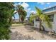 Brick paved patio area with tropical landscaping at 9 Grace St, Crystal Beach, FL 34681