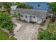 Single story home with brick paved driveway and mature landscaping at 9 Grace St, Crystal Beach, FL 34681