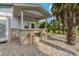 Outdoor patio bar with stone facade and two pink stools at 9 Grace St, Crystal Beach, FL 34681