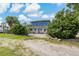 House exterior view with lush landscaping and gravel driveway at 9 Grace St, Crystal Beach, FL 34681