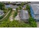 Aerial view of canal-front home with patio and yard at 9 Grace St, Crystal Beach, FL 34681