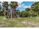 Landscaped backyard with tropical plants and grassy area at 9 Grace St, Crystal Beach, FL 34681