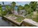 Private backyard with patio, lush landscaping and waterfront access at 9 Grace St, Crystal Beach, FL 34681