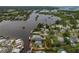 Aerial view of canal-front home with a large backyard and surrounding neighborhood at 9 Grace St, Crystal Beach, FL 34681