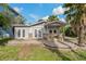 House exterior with stone patio, covered entrance and lush landscaping at 9 Grace St, Crystal Beach, FL 34681