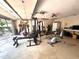 Garage with home gym setup, including weight machine and exercise bike at 10220 Lakeview Dr, New Port Richey, FL 34654