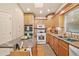Bright kitchen featuring an island, wood cabinets, and a gas range at 1501 28Th N Ave, St Petersburg, FL 33704