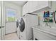 Laundry room with washer, dryer, sink, and upper cabinets at 1501 28Th N Ave, St Petersburg, FL 33704