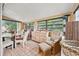 Sunroom with large windows, a recliner, and a wooden dresser at 1501 28Th N Ave, St Petersburg, FL 33704