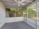 Spacious screened porch with ceiling fan, overlooking backyard at 3124 Lecanto St, Holiday, FL 34691