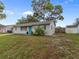 Charming single-story home with teal front door at 3124 Lecanto St, Holiday, FL 34691