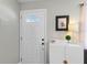 Bright entryway with white door and storage cabinet at 3124 Lecanto St, Holiday, FL 34691