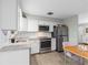 Updated kitchen, featuring granite countertops and white cabinetry at 3124 Lecanto St, Holiday, FL 34691