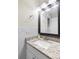 Updated bathroom with granite countertop and a large vanity mirror at 3124 Lecanto St, Holiday, FL 34691