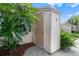 Exterior view of a small tan colored storage shed next to a house at 3849 Staysail Ln, Holiday, FL 34691