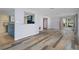 Living room with hardwood floors and view into the kitchen at 3849 Staysail Ln, Holiday, FL 34691
