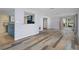 Living room with hardwood floors and view into the kitchen at 3849 Staysail Ln, Holiday, FL 34691