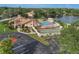 Aerial view of community pool, shuffleboard courts, and clubhouse at 3849 Staysail Ln, Holiday, FL 34691