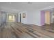 Open living room with wood-look floors and access to the patio at 3849 Staysail Ln, Holiday, FL 34691