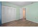 Bedroom with double closets and wood-look floors at 3849 Staysail Ln, Holiday, FL 34691