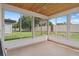 Sunroom with tiled flooring and view of backyard at 3849 Staysail Ln, Holiday, FL 34691