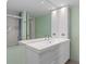 Modern bathroom with double vanity and large mirror at 3849 Staysail Ln, Holiday, FL 34691