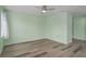 Spacious bedroom with light green walls and wood-look floors at 3849 Staysail Ln, Holiday, FL 34691