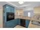 Contemporary kitchen with teal cabinets and granite countertops at 3849 Staysail Ln, Holiday, FL 34691