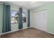 Bedroom with double closets and wood-look floors at 3849 Staysail Ln, Holiday, FL 34691