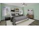 Bedroom with light green walls, wood-look floors, and staged furniture at 3849 Staysail Ln, Holiday, FL 34691