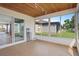 Spacious sunroom with tiled floors and access to backyard at 3849 Staysail Ln, Holiday, FL 34691