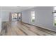 Open living area with hardwood floors and multiple windows for natural light at 3849 Staysail Ln, Holiday, FL 34691