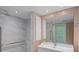 Bathroom with walk-in shower, grab bars, and a large mirror at 3849 Staysail Ln, Holiday, FL 34691