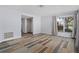 Living room with wood-look floors and a view to backyard at 3849 Staysail Ln, Holiday, FL 34691