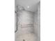Modern bathroom with marble shower and grab bars at 3849 Staysail Ln, Holiday, FL 34691